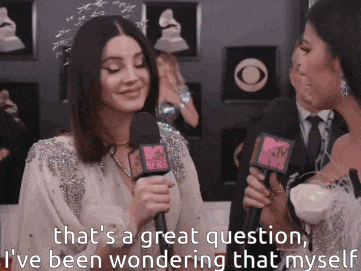two women are talking into microphones and one of them says that 's a great question