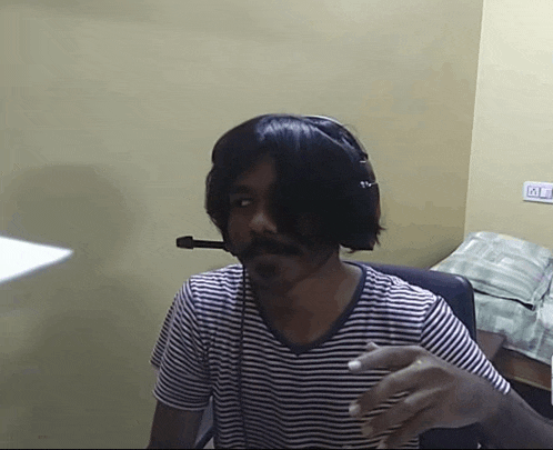 a man in a striped shirt is wearing headphones