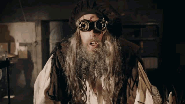 a man with a beard and goggles on his face