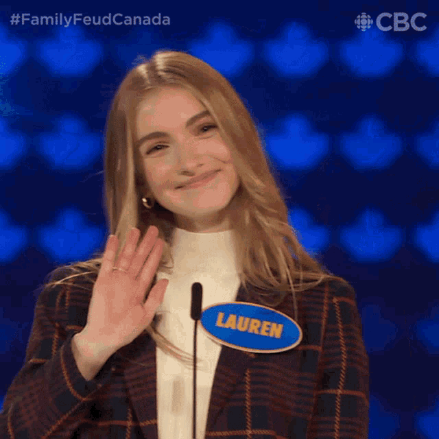 a woman with a name tag that says lauren is smiling and waving