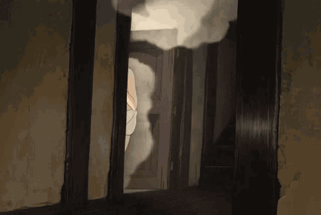 a woman is standing in a doorway with smoke coming out of the door .