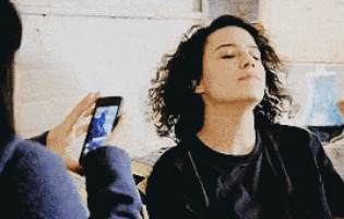 a person is taking a picture of a woman with their phone