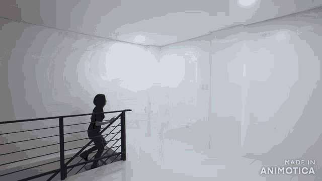 a person walking up a set of stairs with the words made in animotica on the bottom