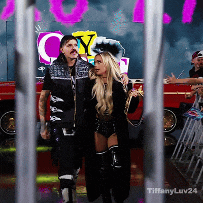 a man and a woman are walking in front of a sign that says city