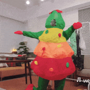 a person in a colorful costume is standing in a living room with a sign that says we