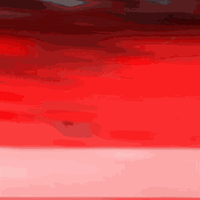 a red background with a white border and a few clouds