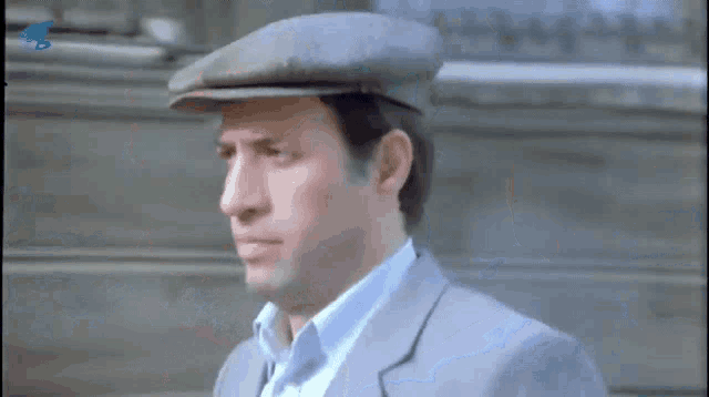 two men are standing next to each other with one wearing a hat