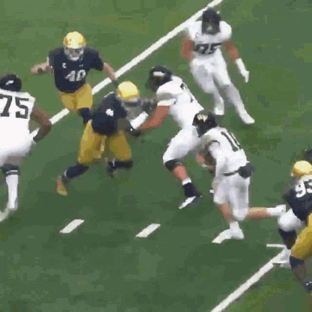 a football player with the number 75 on his jersey is running with the ball