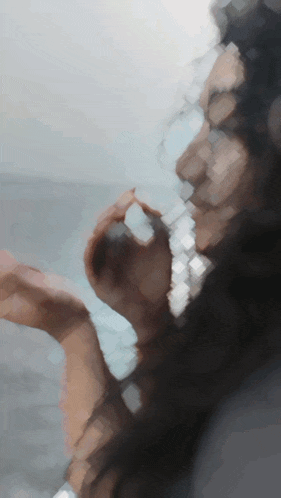a blurry picture of a woman 's face with a blue background