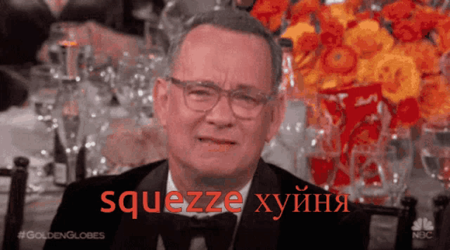 a man in a tuxedo and glasses says squeeze in red letters