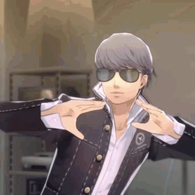 a man wearing sunglasses and a jacket with the letter t on the front