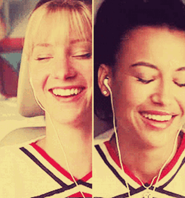 two cheerleaders are smiling and listening to music with their eyes closed
