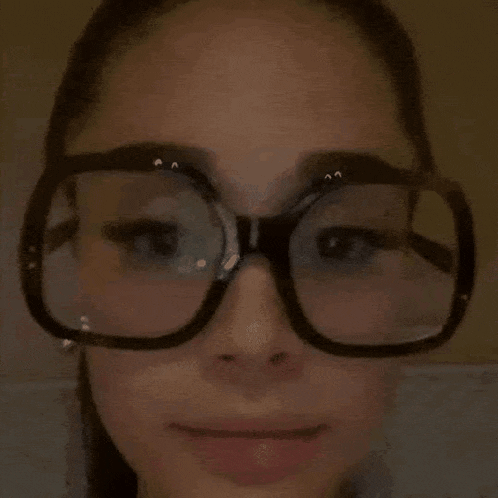 a close up of a woman wearing glasses