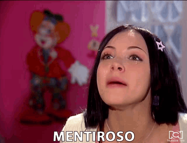 a woman is crying in front of a pink wall and the word mentiraso is on the screen