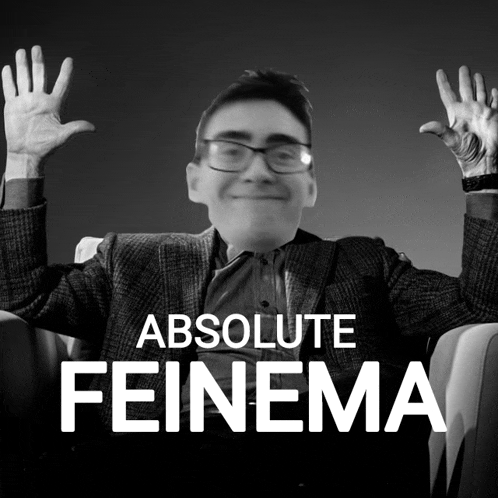 a black and white photo of a man with his hands in the air and the words absolute feinema below him