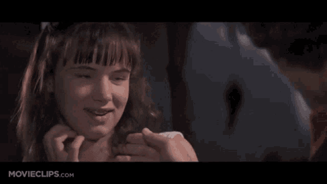 a close up of a girl 's face with movieclips.com on the bottom of the screen