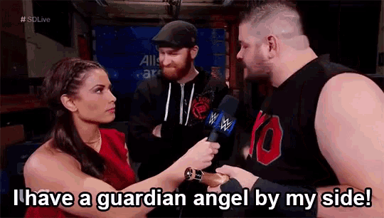 a woman is talking to a man with a microphone and says i have a guardian angel by my side