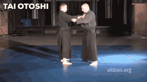 two men are practicing martial arts and the words tai otoshi are on the screen