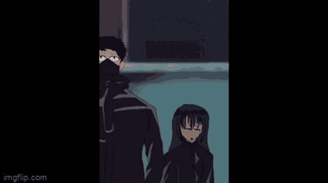 a man and a woman are standing next to each other . the man is wearing a mask .