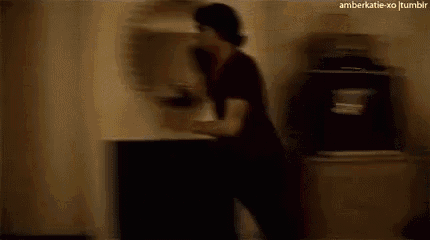 a blurry picture of a person walking through a doorway .