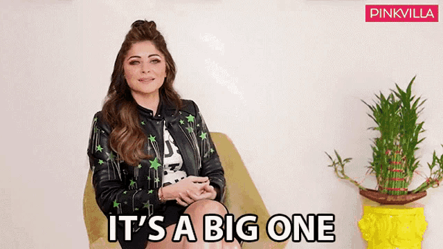 a woman sitting in a chair with the words it 's a big one on the bottom