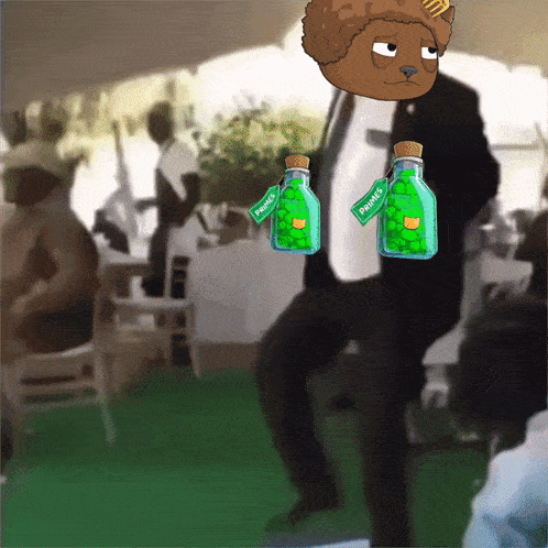 a man in a suit is holding two bottles that say pawpaw 's on them