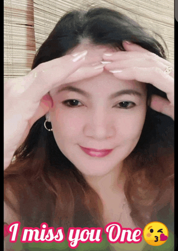 a woman with her hands on her forehead with the words i miss you one below her