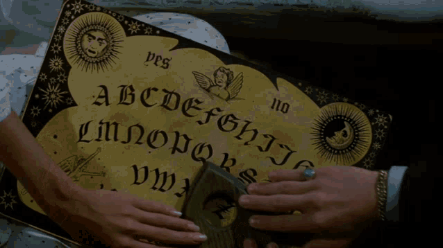 a ouija board with the letters abcdefghijklmnopqrstuvwxyz on it