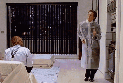 a man in a clear coat is standing in a room