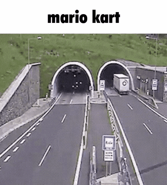 a truck is going through a tunnel on a highway .