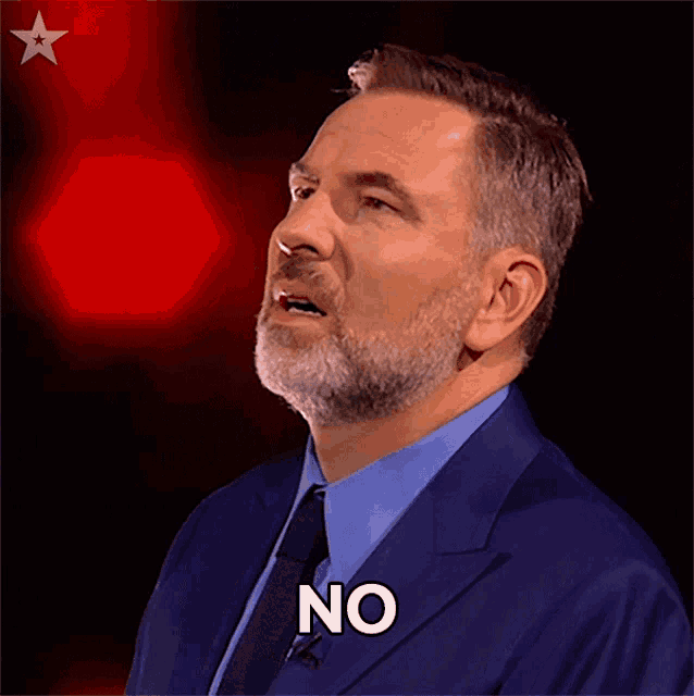 a man in a suit and tie with the word no on his face