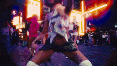 a group of people are dancing in front of a sign that says weds on it