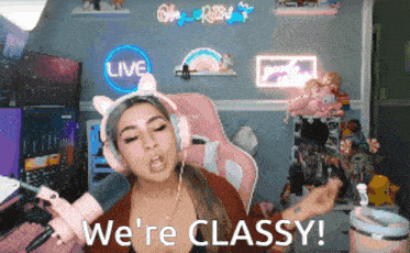 a woman wearing headphones says we 're classy in front of a live sign
