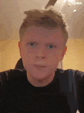 a close up of a young man 's face with the word luma in the corner