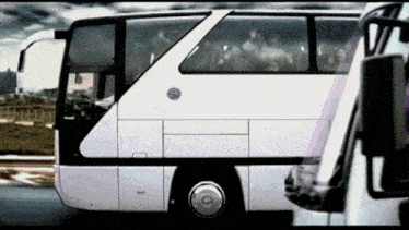 a white bus has a sticker on the side that says ' volvo '