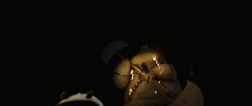 a person holding a candle in the dark
