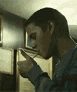 a man in a blue sweater is drinking from a glass .