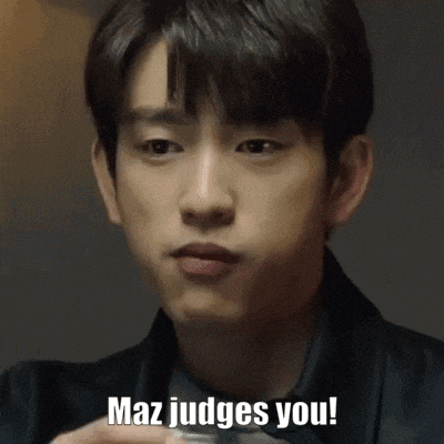 a man is holding a cup of coffee and saying `` maz judges you '' .