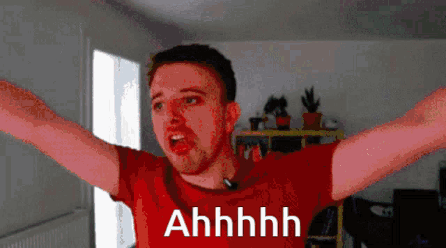 a man in a red shirt with his arms outstretched and the word ahhhh on the bottom