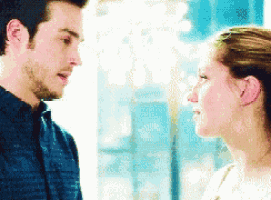 a man and a woman are looking at each other and talking .