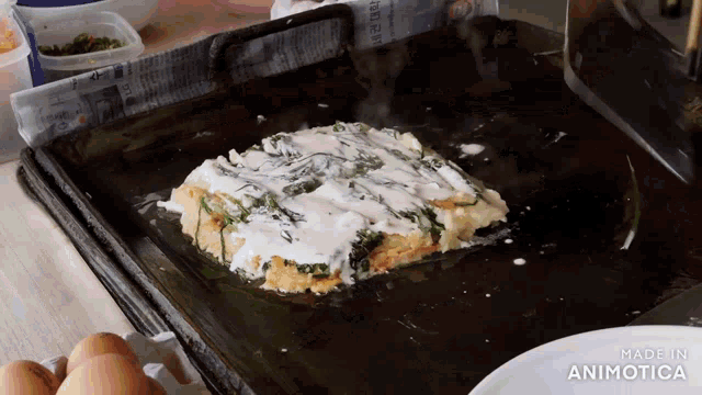 a piece of food is being cooked on a grill with the words made in animotica visible