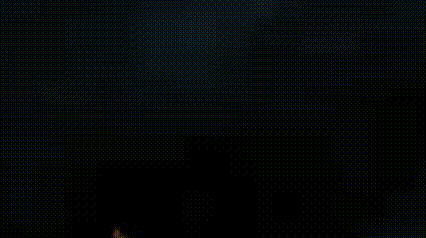 a blurred image of a person riding a bike in the dark .