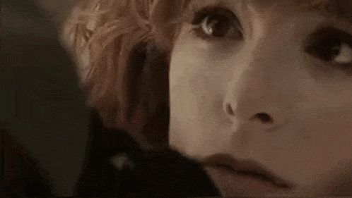 a close up of a woman 's face with her eyes closed