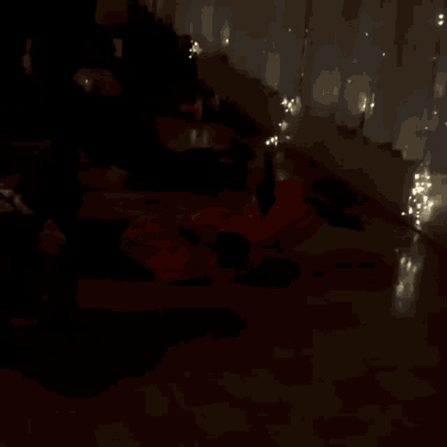 a person is laying on the floor in a dark room with lights behind them