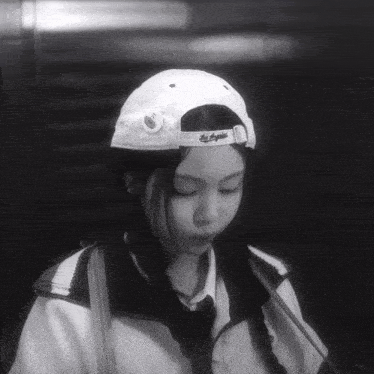 a girl wearing a hat that says los angeles on the back