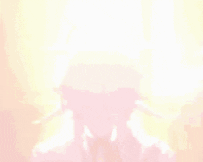 a man with a helmet on his head is standing in front of a light .