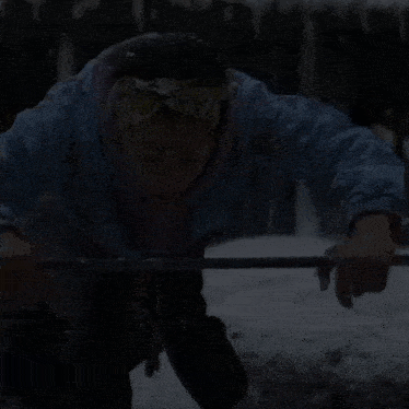 a woman in a blue jacket screams in the dark