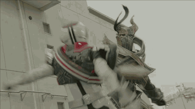 a man in a white helmet is fighting another man in a black and gold armor