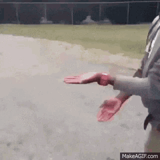 a person wearing a watch is holding a baseball glove .