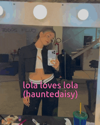 a woman taking a selfie in front of a mirror with the words lola loves lola haunted daisy on the bottom